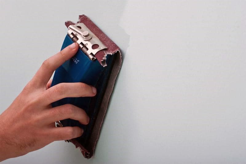 Обробка стін наждачним папером перед фарбуванням